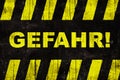 Gefahr in German, Ã¢â¬ÅdangerÃ¢â¬Â text warning sign with yellow and black stripes